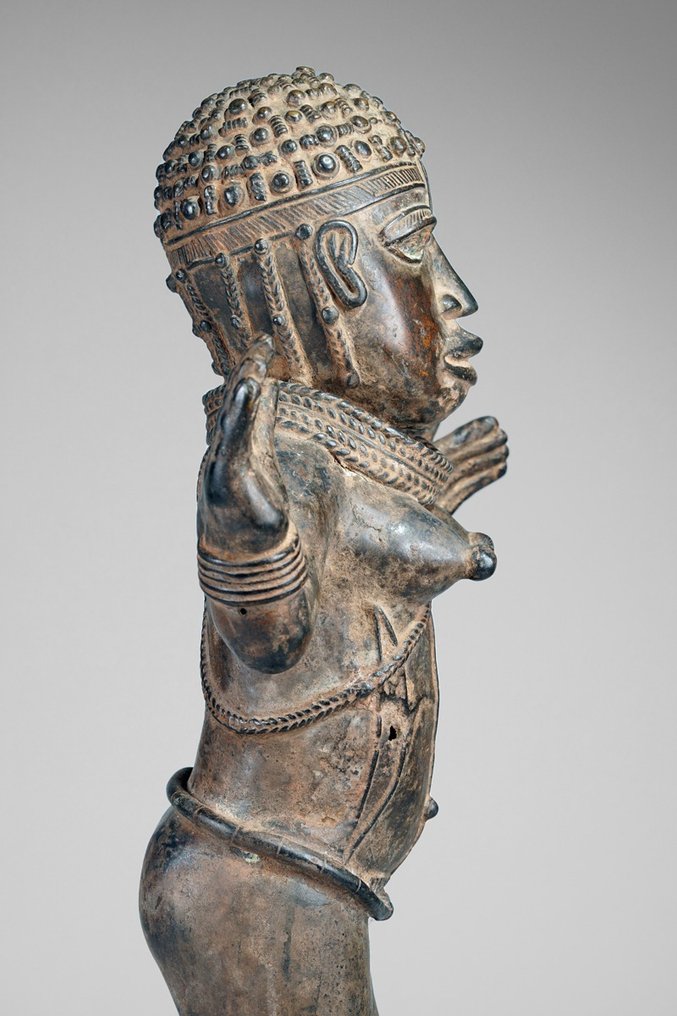 A female Bronze sculpture, in the style of Benin