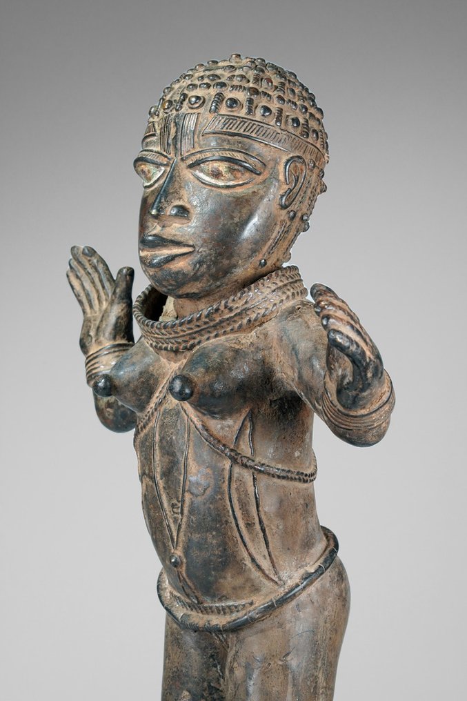 A female Bronze sculpture, in the style of Benin