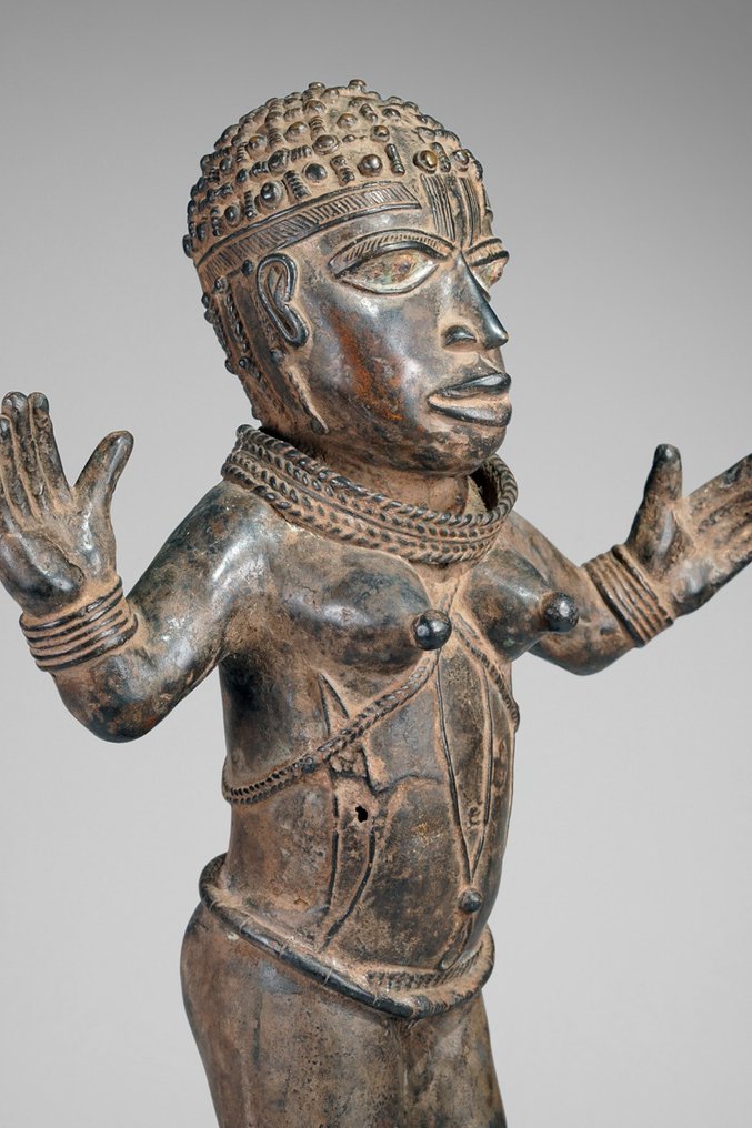 A female Bronze sculpture, in the style of Benin