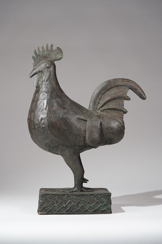 A brass rooster in the style of Benin