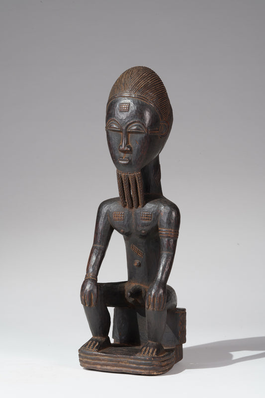 A seated male Baule sculpture