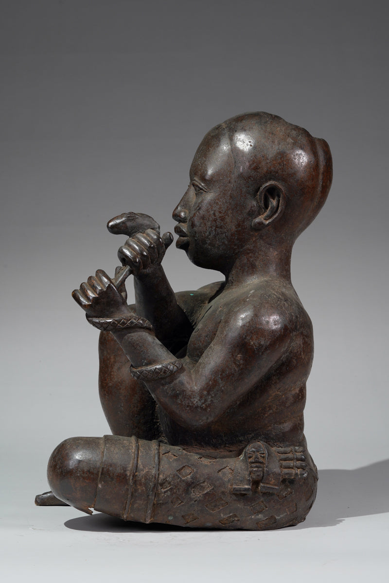 An Ife style bronze of the seated figure of Tada