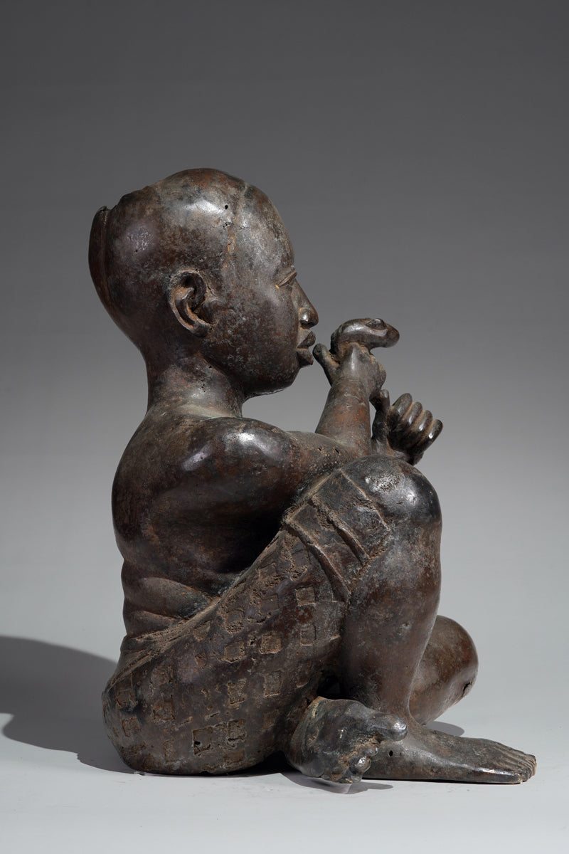 An Ife style bronze of the seated figure of Tada