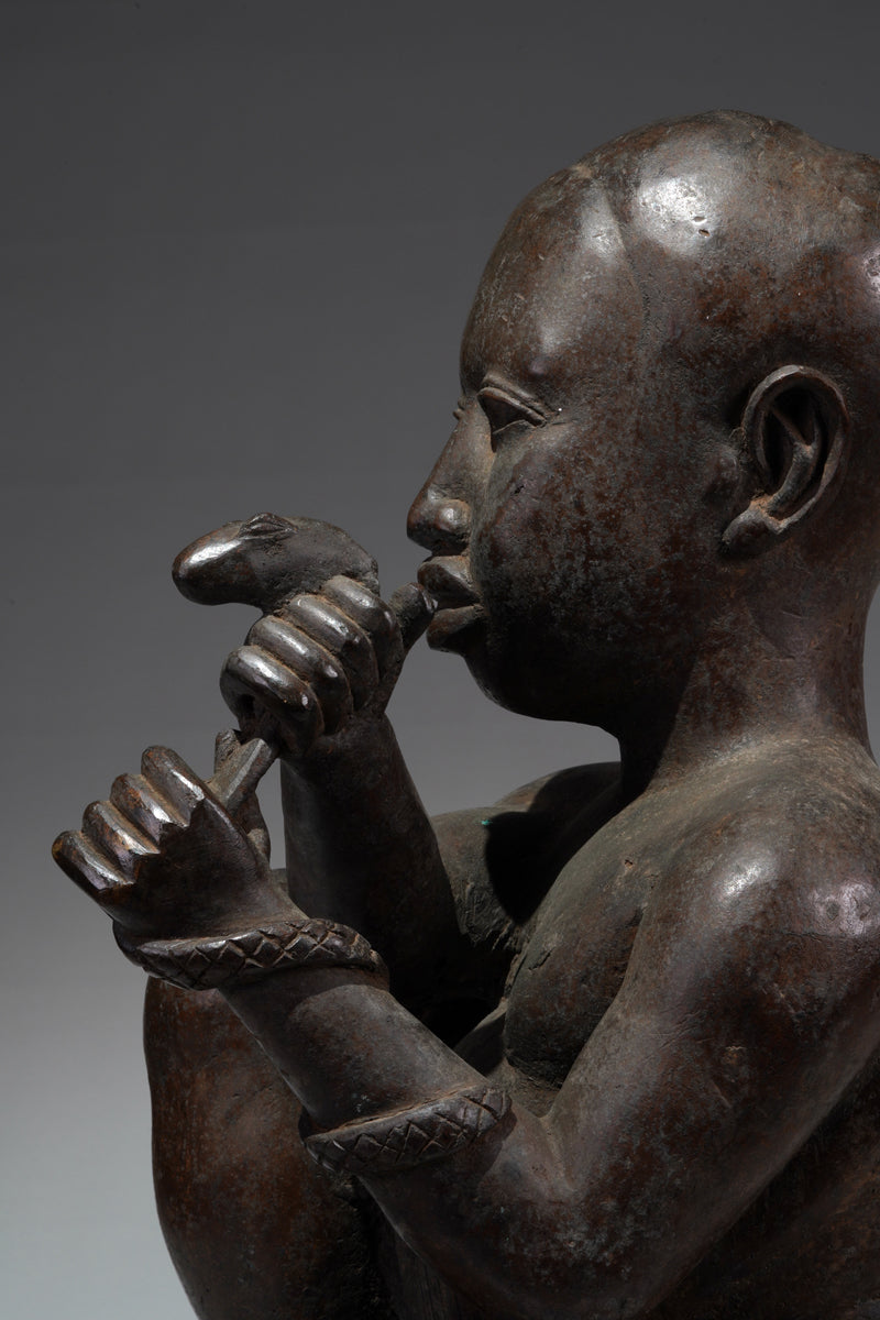 An Ife style bronze of the seated figure of Tada