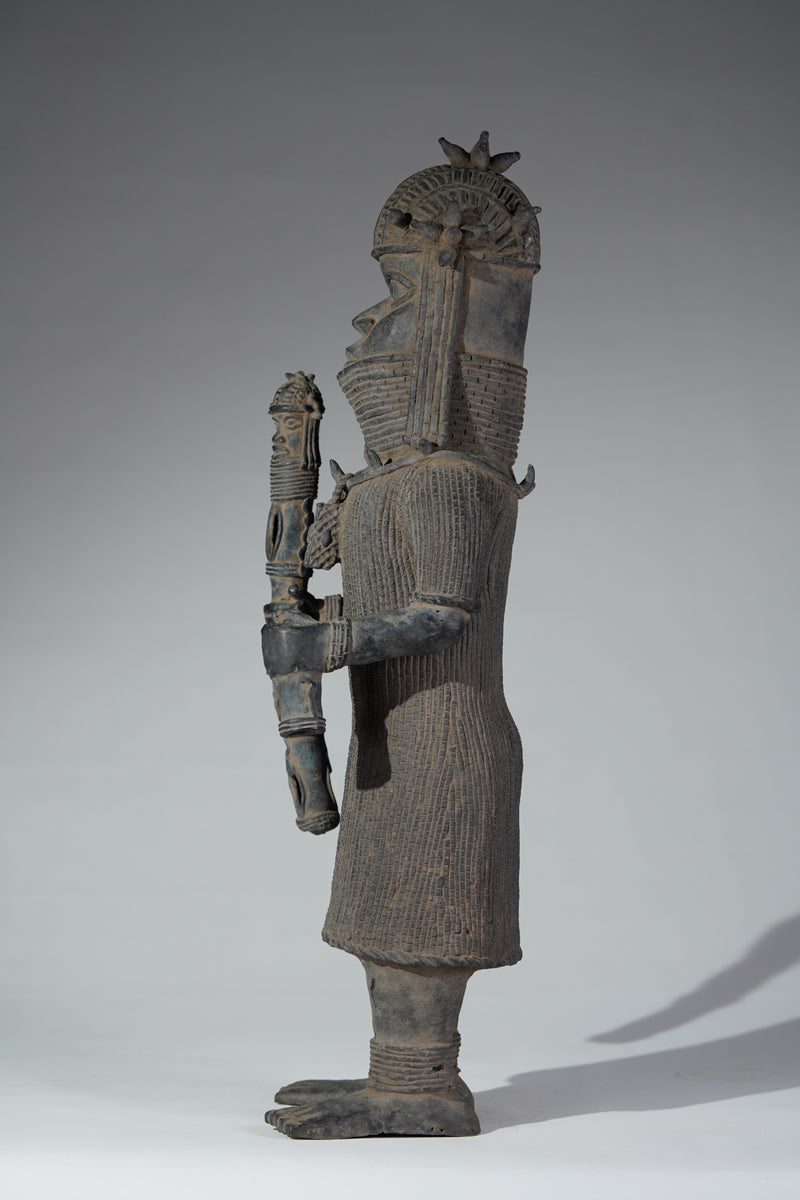 This cast brass figure of an Oba