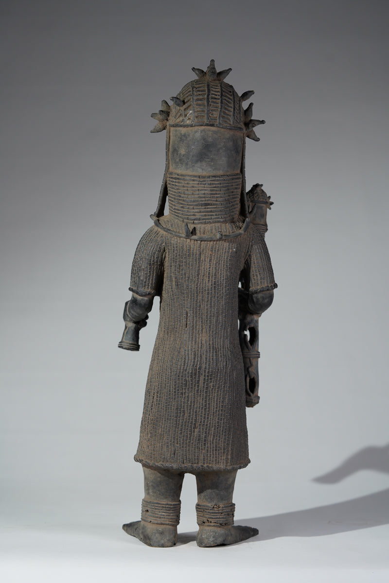 This cast brass figure of an Oba