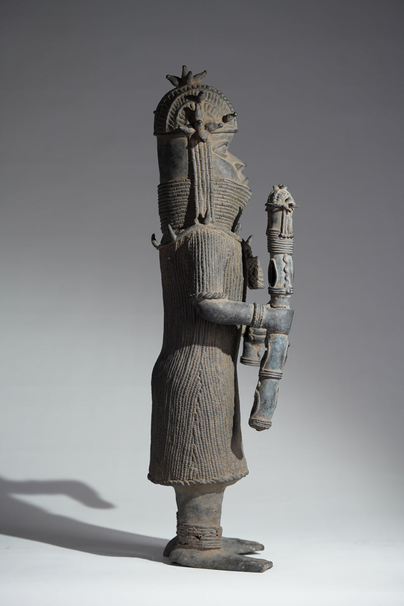 This cast brass figure of an Oba