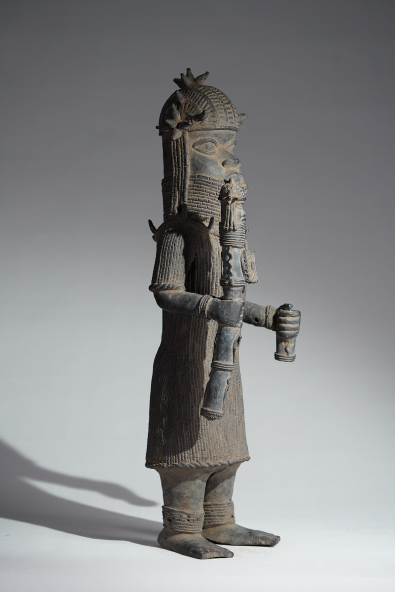 This cast brass figure of an Oba