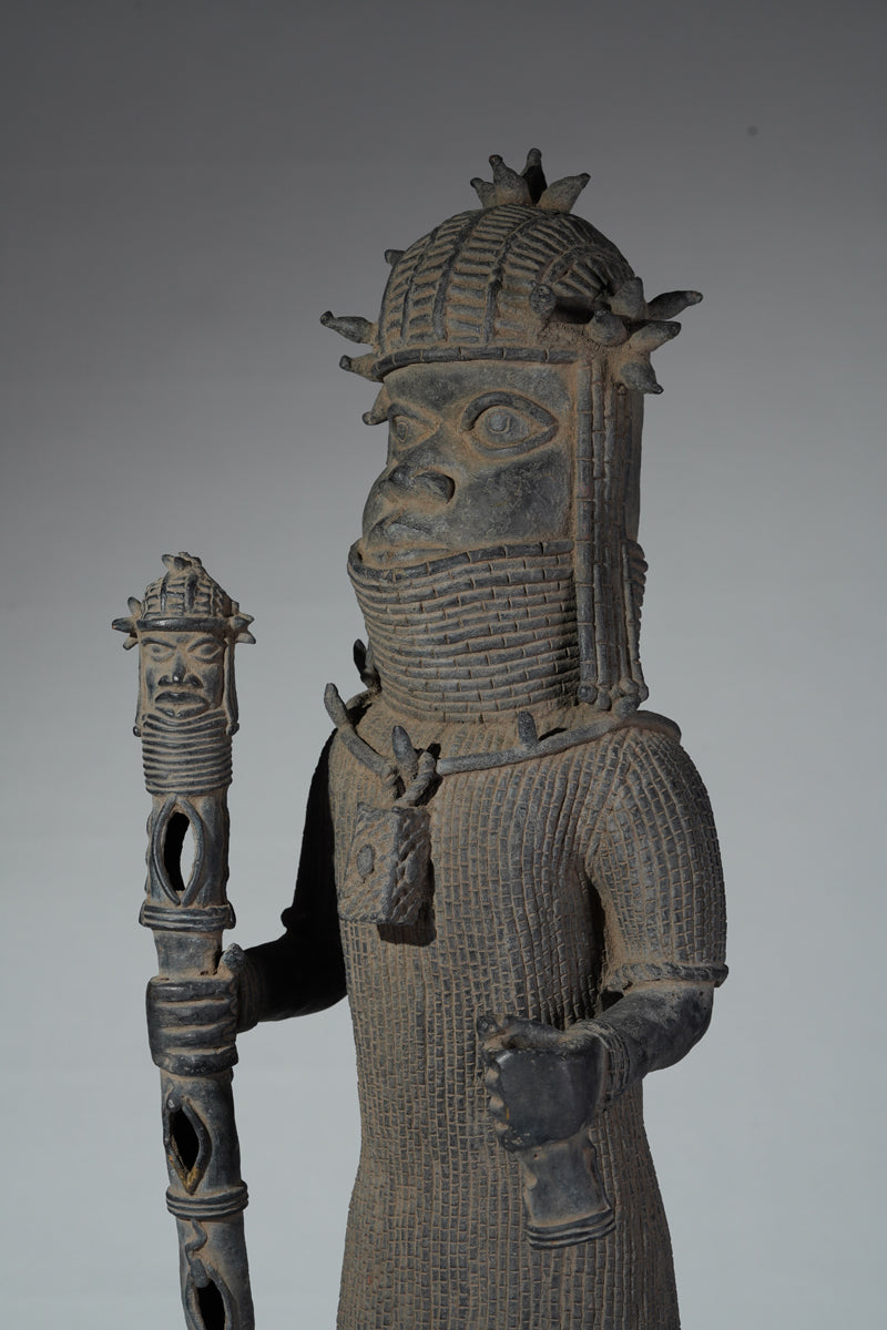 This cast brass figure of an Oba