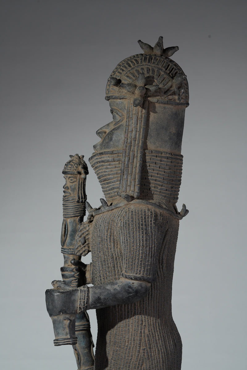 This cast brass figure of an Oba