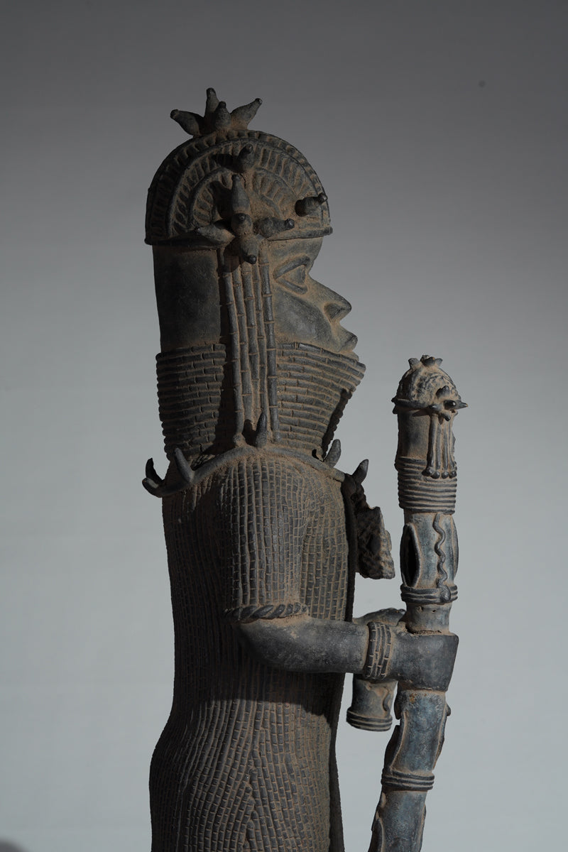 This cast brass figure of an Oba