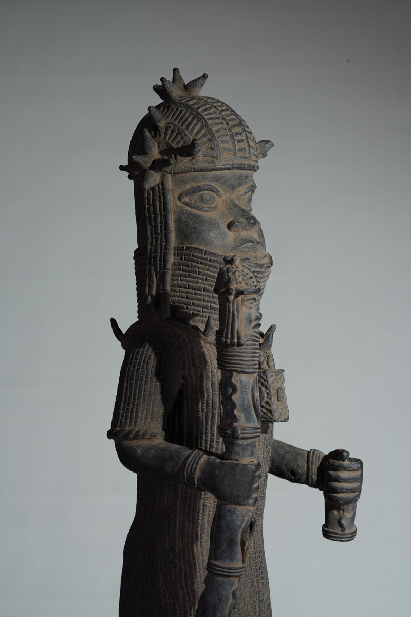This cast brass figure of an Oba