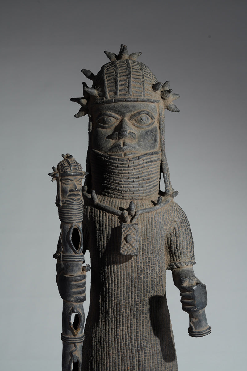 This cast brass figure of an Oba