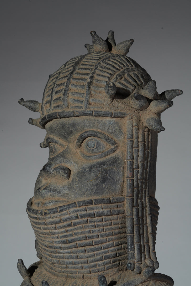 This cast brass figure of an Oba