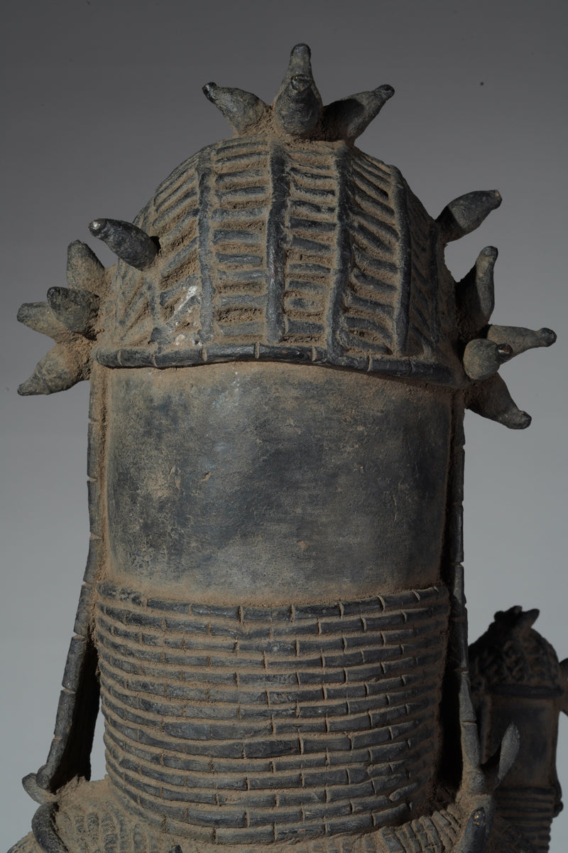 This cast brass figure of an Oba