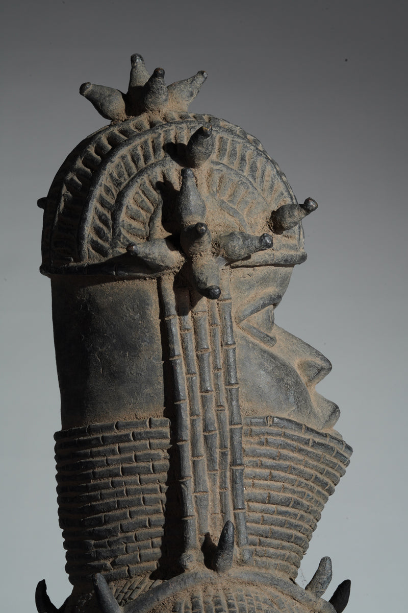 This cast brass figure of an Oba
