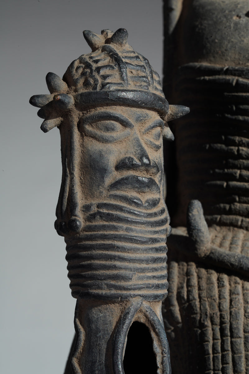 This cast brass figure of an Oba