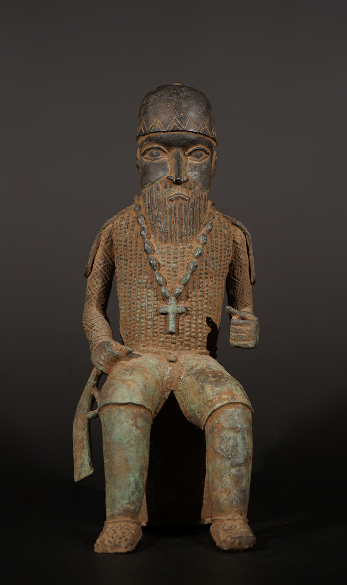 A Bronze in the style of Benin of a sitting Portuguese soldier