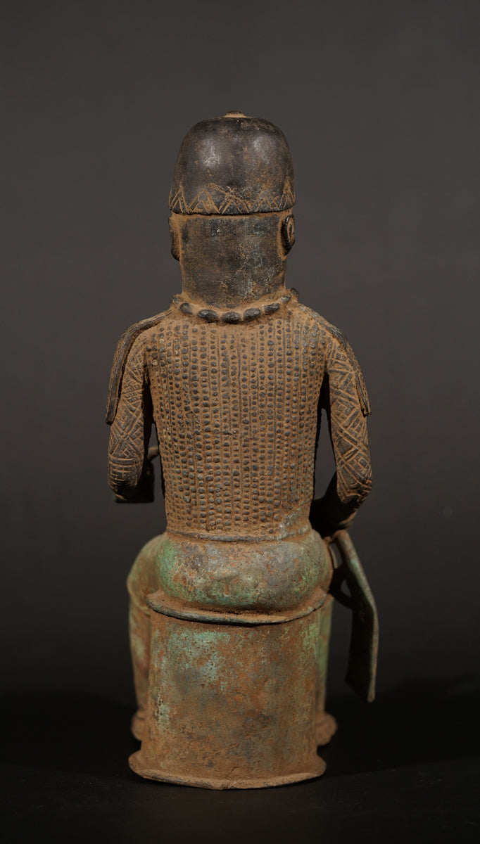 A Bronze in the style of Benin of a sitting Portuguese soldier