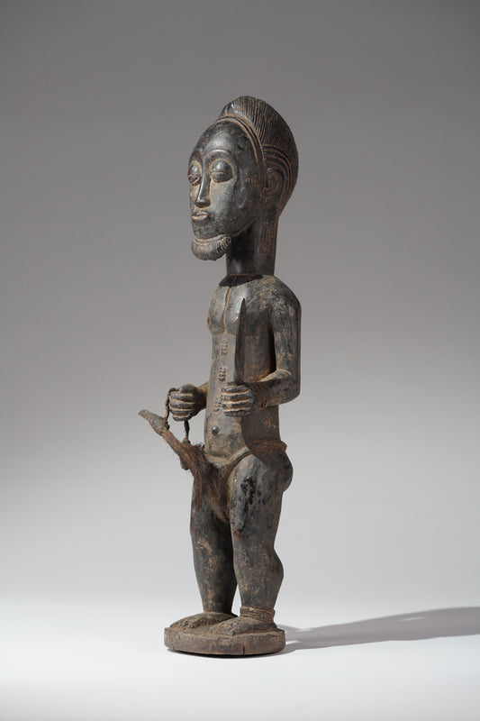 A male Baule hunter statue