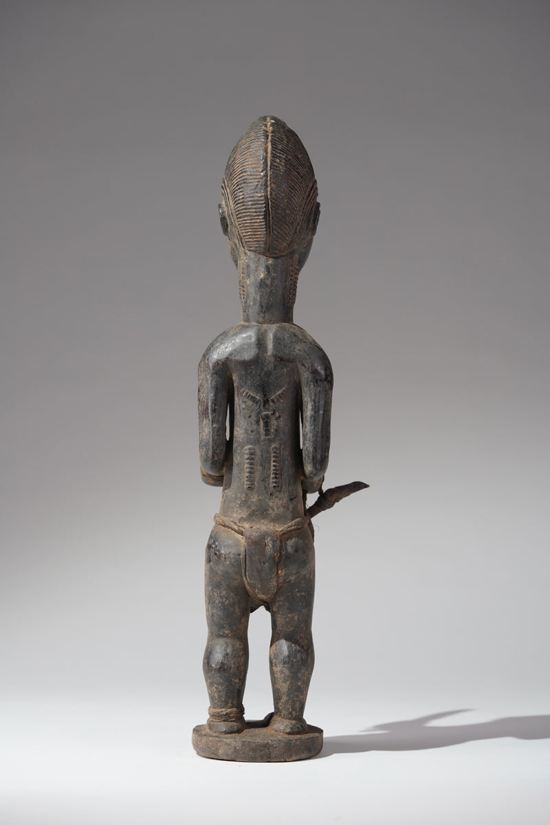 A male Baule hunter statue