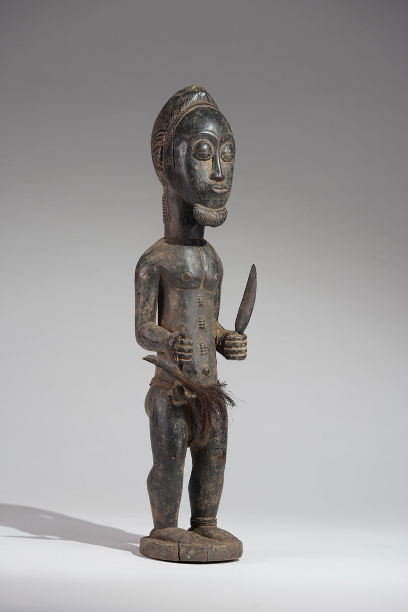 A male Baule hunter statue