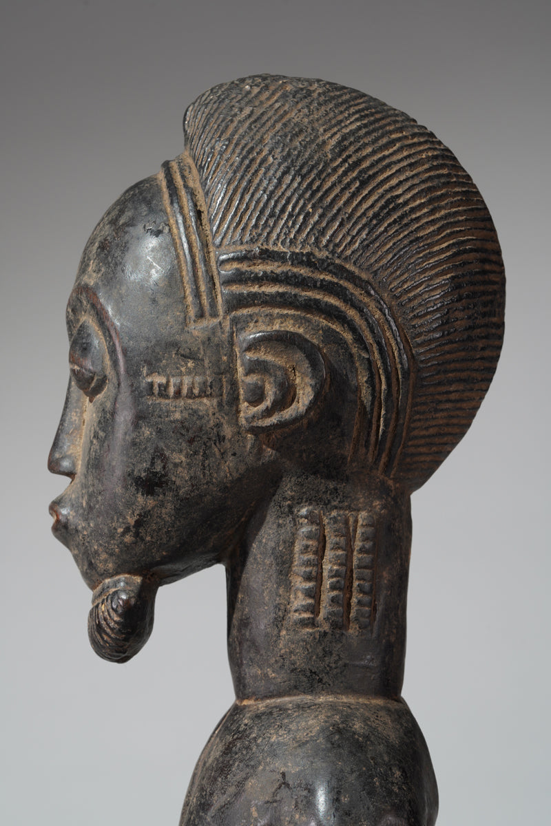A male Baule hunter statue