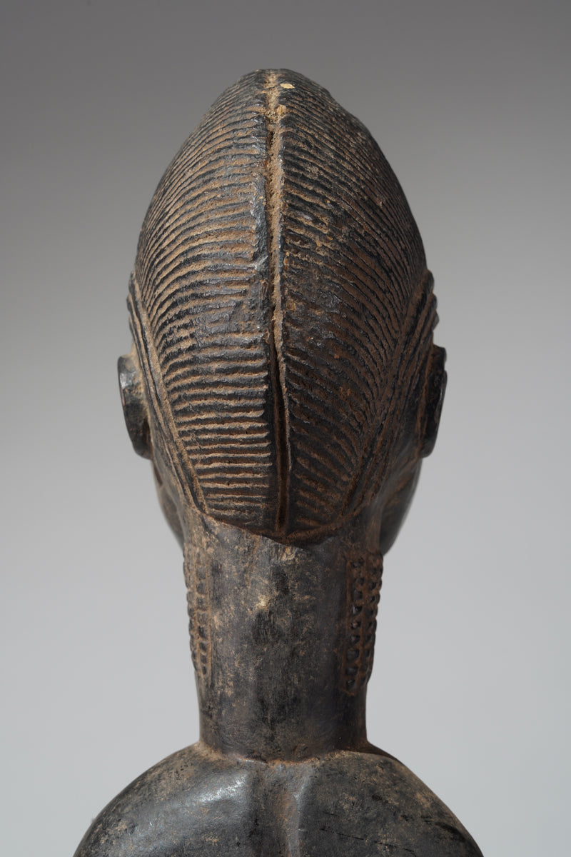 A male Baule hunter statue