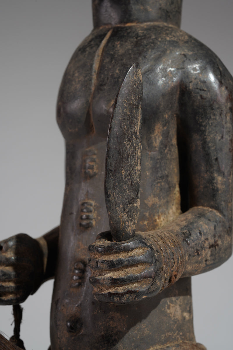 A male Baule hunter statue