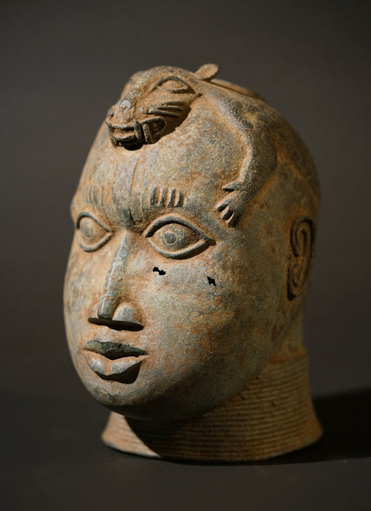 A Benin Bronze head with a stylized panther on top