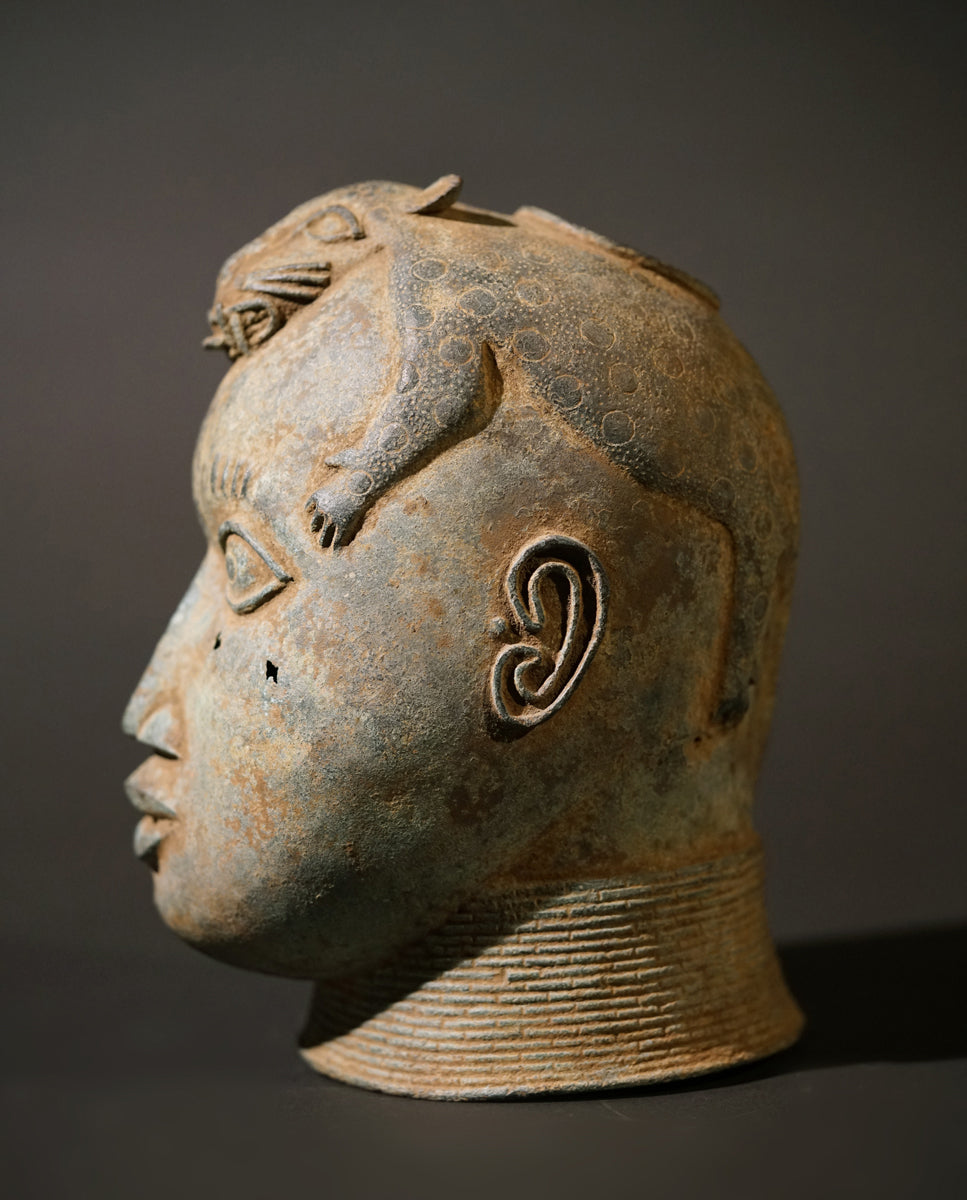 A Benin Bronze head with a stylized panther on top