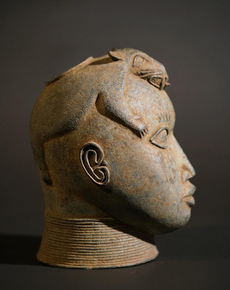 A Benin Bronze head with a stylized panther on top