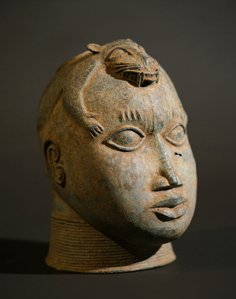 A Benin Bronze head with a stylized panther on top