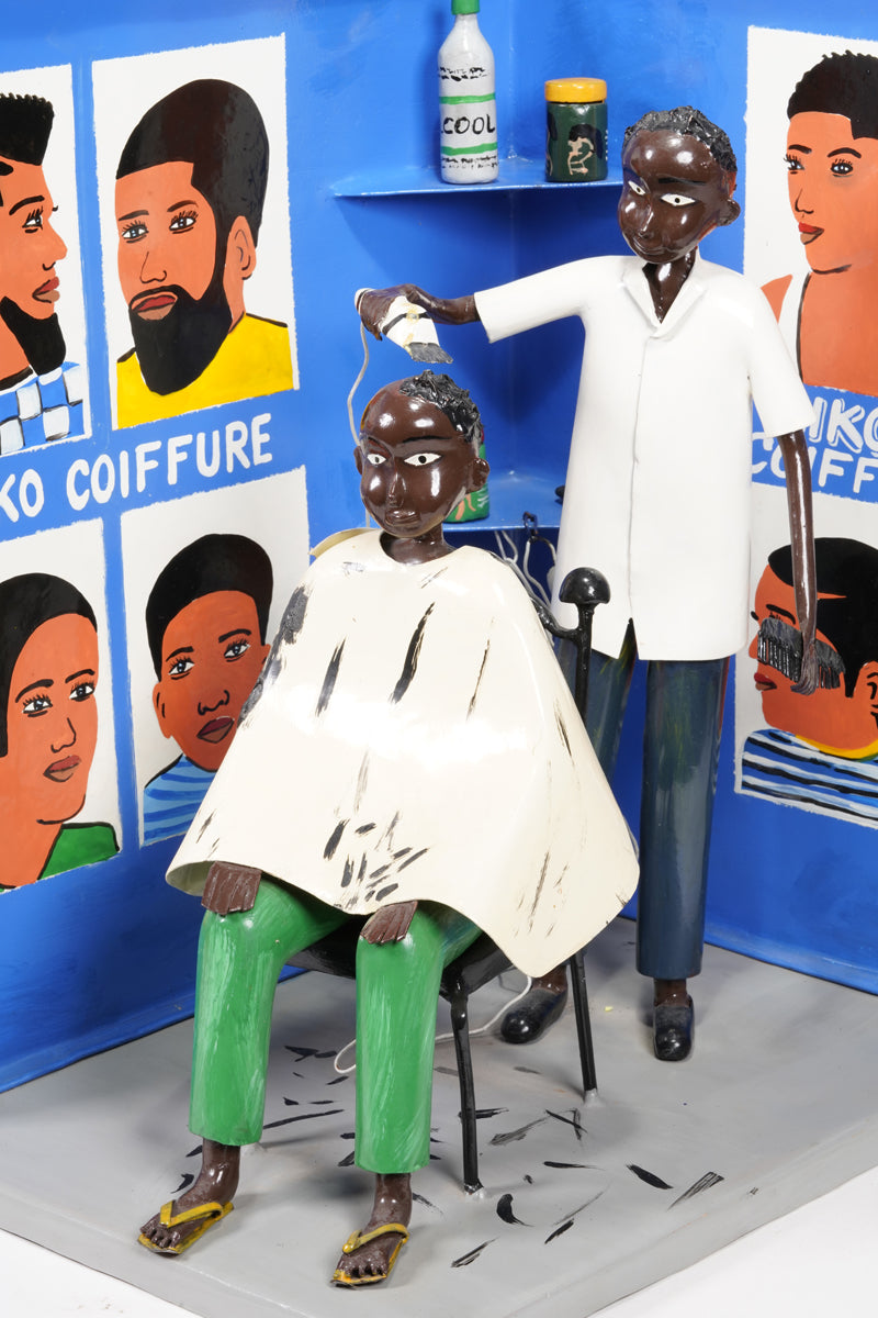 Barbershop scene where a customer sits