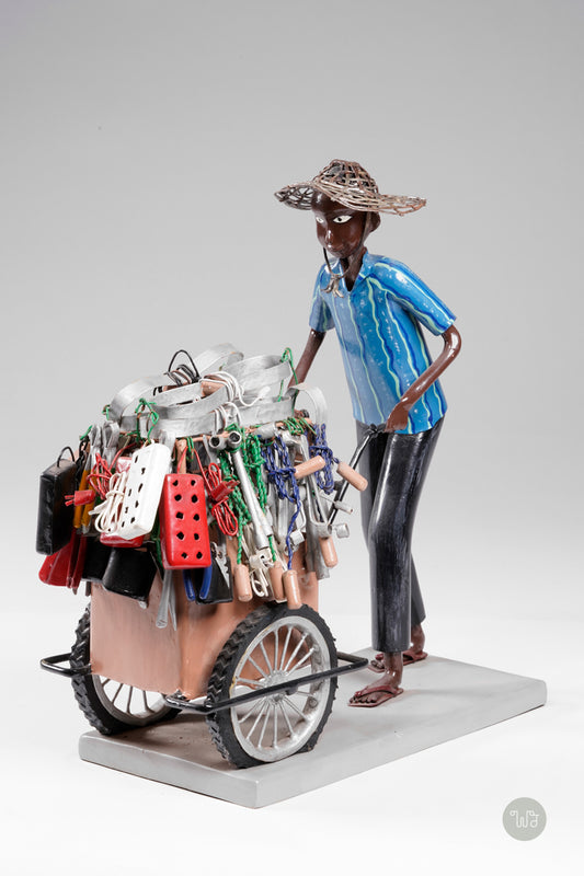A salesman pushing his goods from the area of a hardware store on a cart