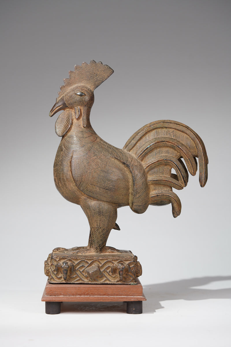 A brass rooster in the style of Benin