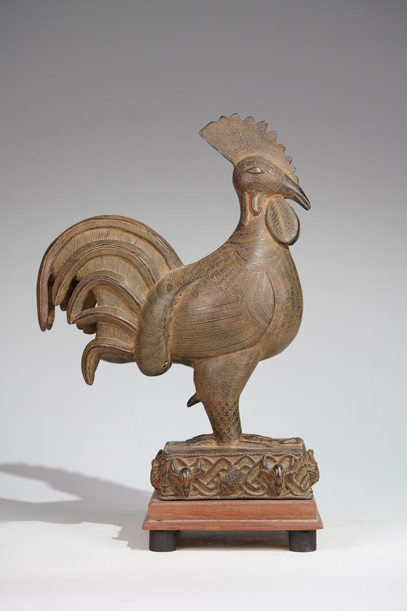 A brass rooster in the style of Benin