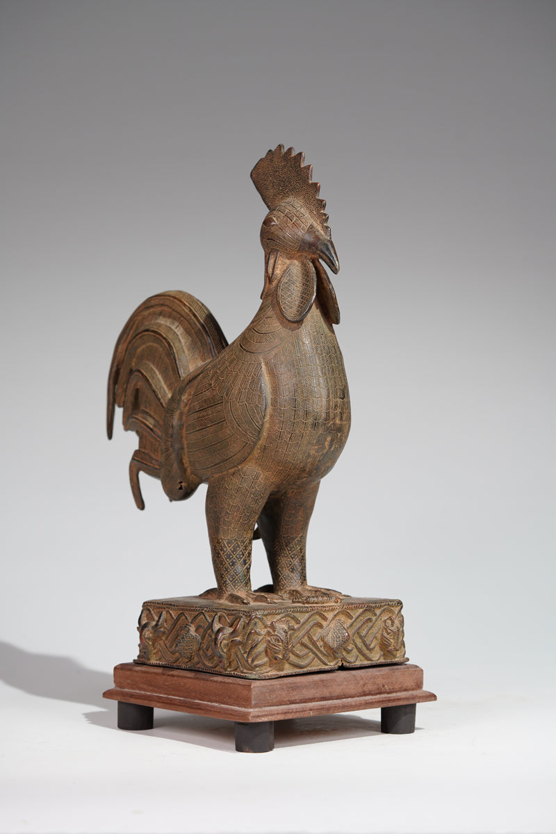 A brass rooster in the style of Benin