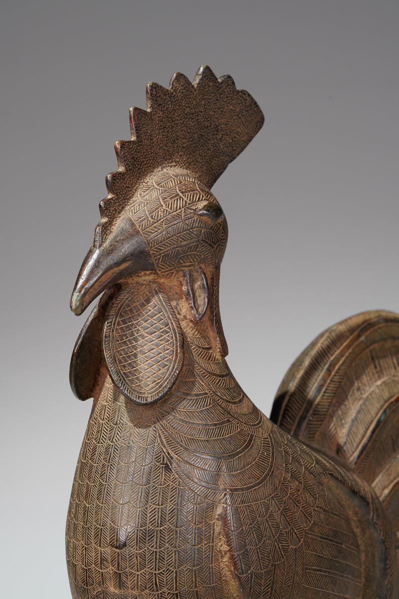 A brass rooster in the style of Benin