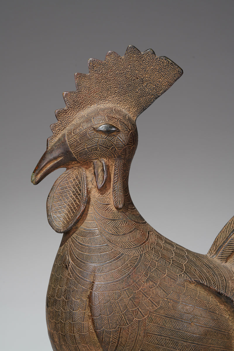 A brass rooster in the style of Benin