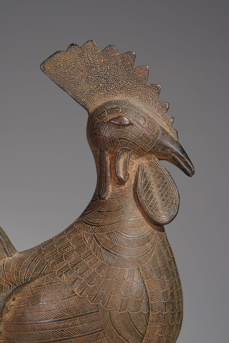 A brass rooster in the style of Benin