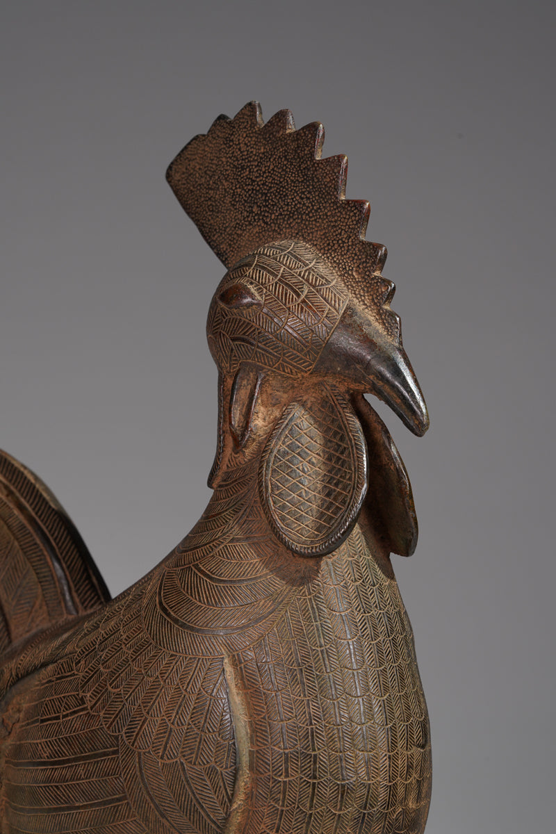 A brass rooster in the style of Benin