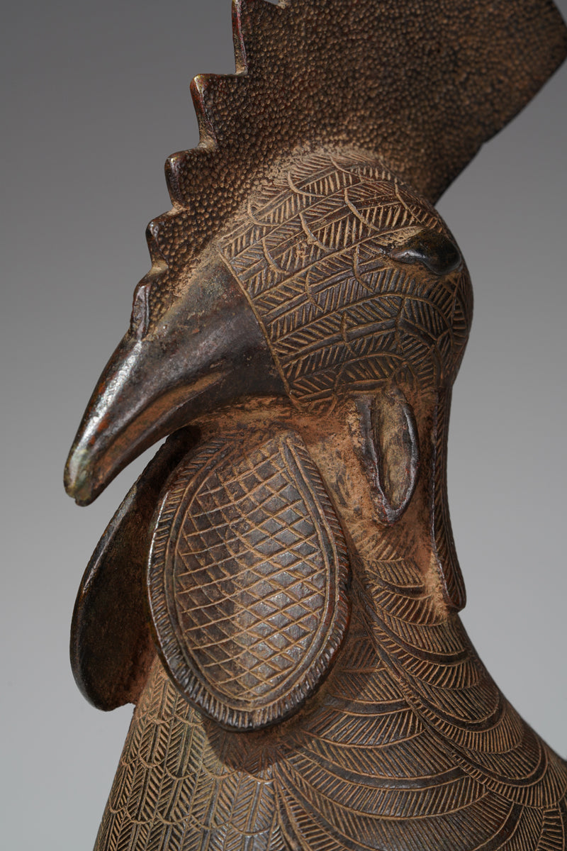 A brass rooster in the style of Benin