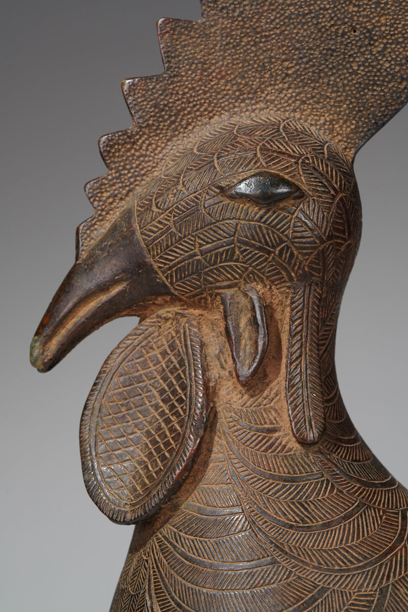 A brass rooster in the style of Benin