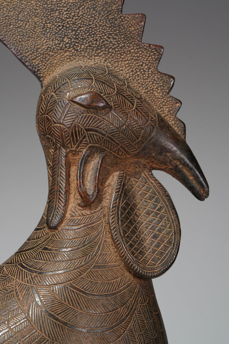 A brass rooster in the style of Benin