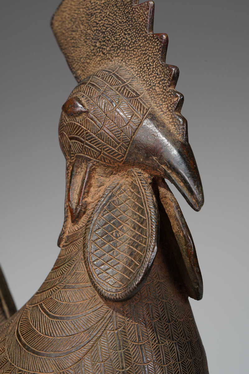 A brass rooster in the style of Benin