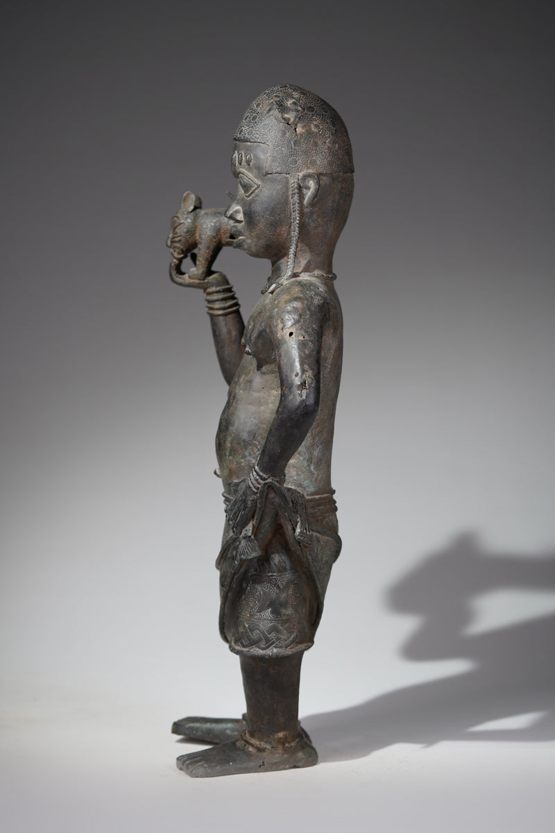 A bronze sculpture of a servant in the style of Benin