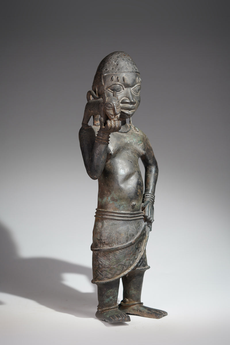 A bronze sculpture of a servant in the style of Benin