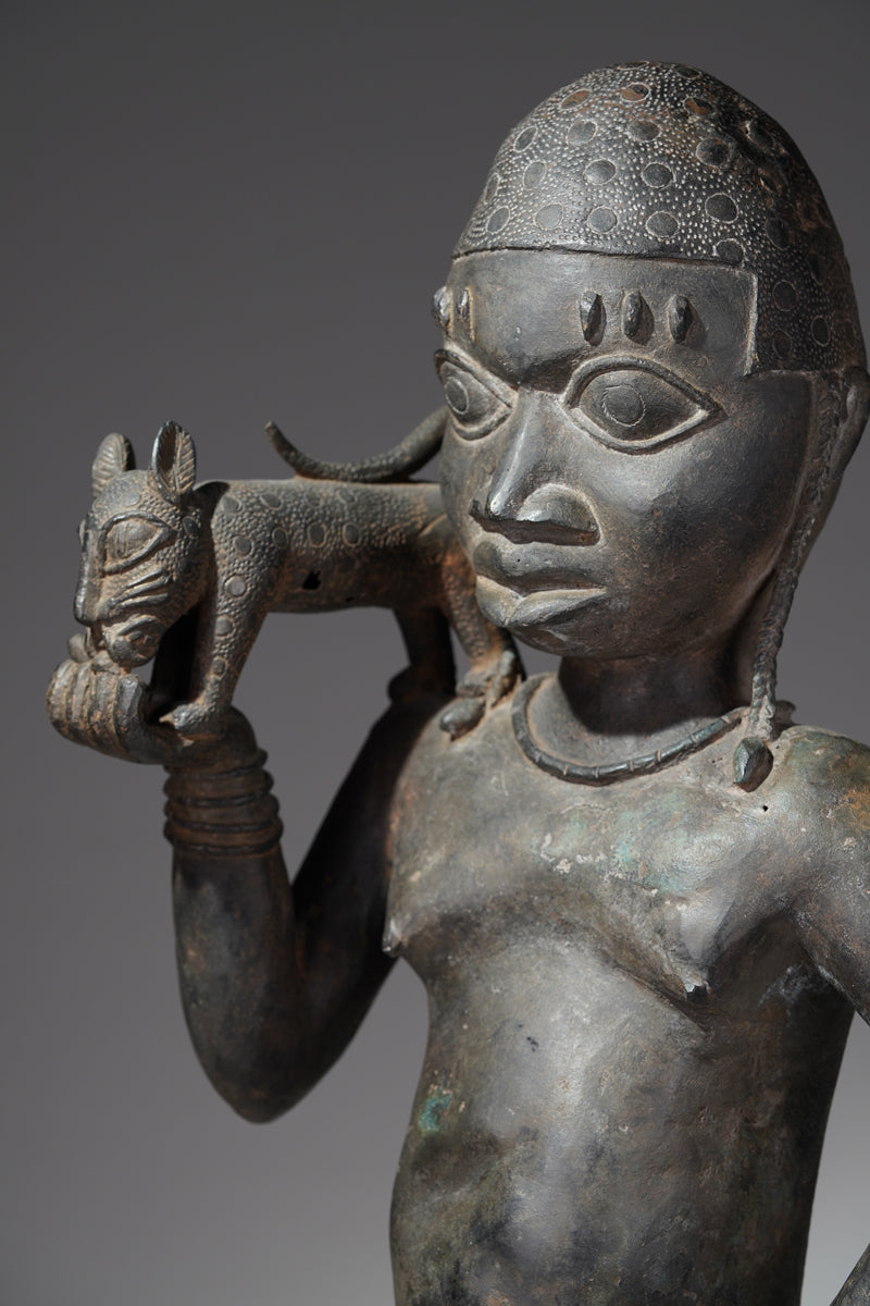 A bronze sculpture of a servant in the style of Benin