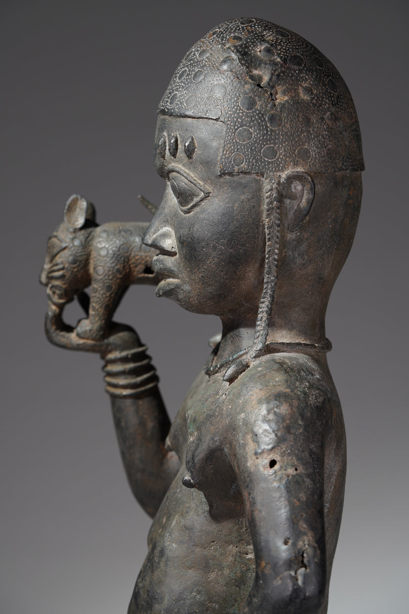 A bronze sculpture of a servant in the style of Benin